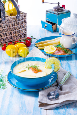 Cream of asparagus soup with salmon rolls and dill