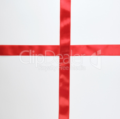 red satin ribbon cross to cross on white background
