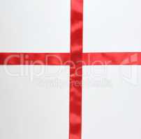 red satin ribbon cross to cross on white background