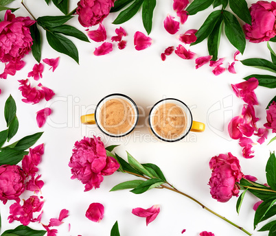 two yellow ceramic cups with black coffee