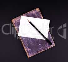 blank white paper card and black wooden pencil