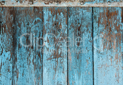 very old wooden background with blue cracked paint