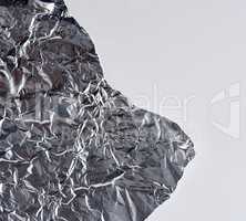 ragged edge of silver foil on a white background