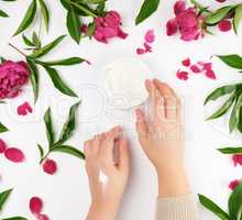 two female hands and a jar with thick cream