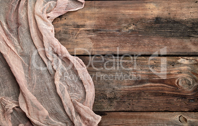 gray textile napkin, brown wooden background