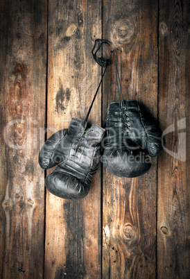 very old leather black boxing gloves hang