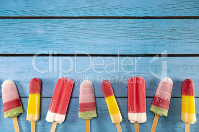Ice cream stick placed on a blue vintage wooden