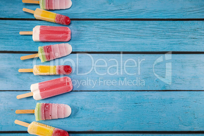 Colorful fruit ice cream stick look fresh to eat placed on a blu