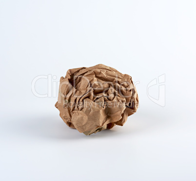 crumpled sheet of brown paper on a white background