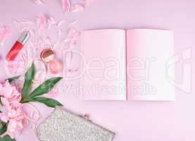 open notebook with blank pink pages, bouquet of peonies