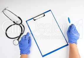 hand in blue sterile gloves and medical stethoscope