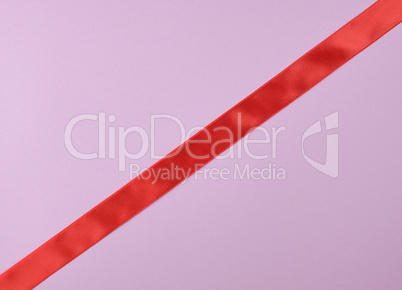 red satin ribbon on a purple  background