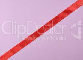 red satin ribbon on a purple  background