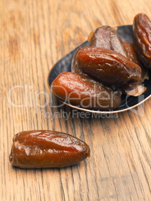 Organic dried dates on wood