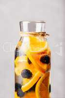 Bottle of Water with Orange and Blackberry.