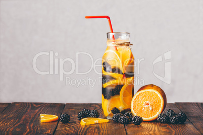 Bottle of Water with Orange and Blackberry