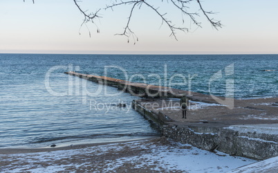 Pier on the beach in winter day