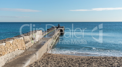 Pier on the beach in winter day