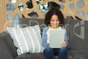 Boy using digital tablet in the lobby at hospital