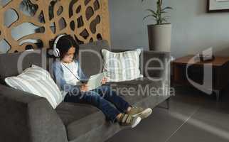 Boy listening music on digital tablet in the lobby at hospital
