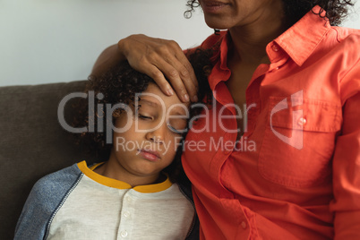 Mother consoling her son in the lobby at hospital