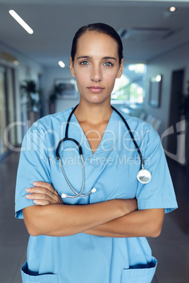 Female doctor standing with arms crossed in the hospital