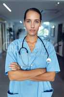 Female doctor standing with arms crossed in the hospital