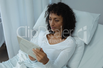 Female patient using digital tablet in the ward at hospital