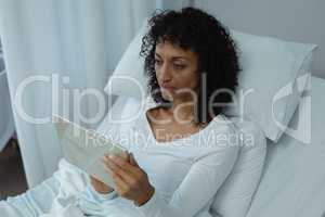 Female patient using digital tablet in the ward at hospital