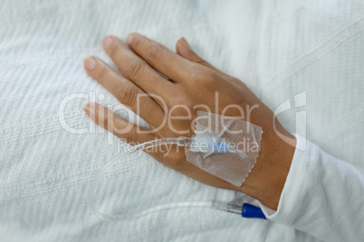 IV drip on a patient hand in the ward at hospital