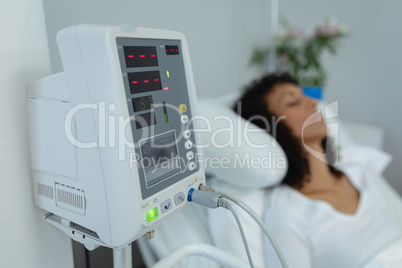Medical monitor with patient in the ward at hospital