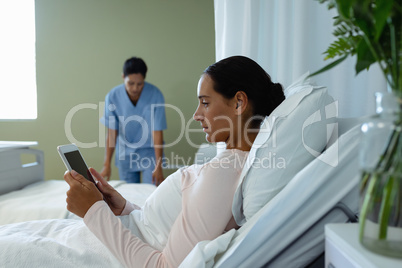 Female patient using digital tablet in the ward at hospital