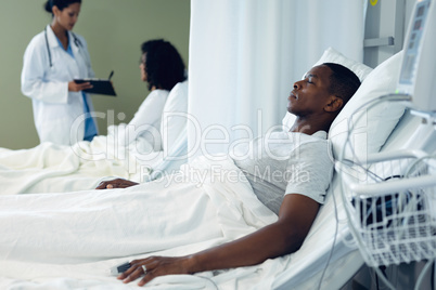 Male patient sleeping in bed in the ward at hospital