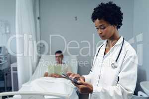 Female doctor using digital tablet in the ward