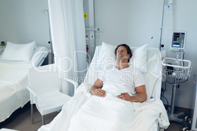 Male patient relaxing on bed in the ward at hospital
