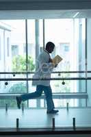 Male doctor running in the corridor at hospital