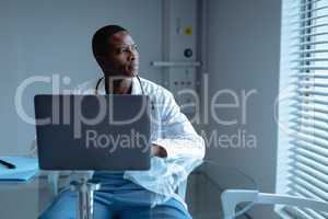 Male doctor using laptop in the hospital