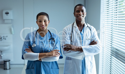 Male and female doctors smiling in hospital