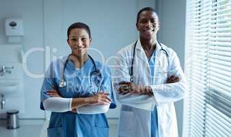 Male and female doctors smiling in hospital