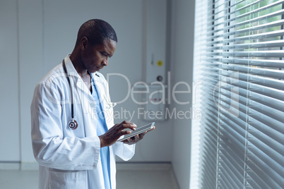 Male doctor using digital tablet in hospital