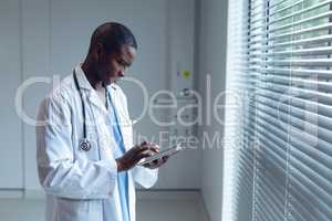 Male doctor using digital tablet in hospital