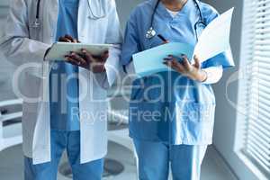 Male and female doctors using digital tablet in the hospital