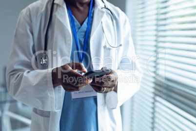 Male doctor using mobile phone in hospital