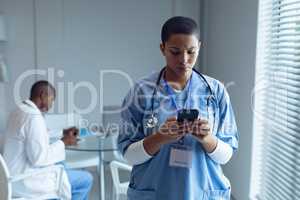 Female doctor using mobile phone in hospital