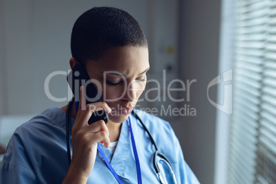 Female doctor talking on mobile phone in hospital Female doctor talking on mobile phone in hospital