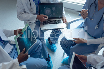 Medical teams discussing over laptop in hospital
