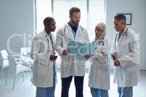 Medical team discussing over medical file at hospital
