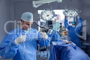 Male surgeon wearing surgical mask in operation room at hospital