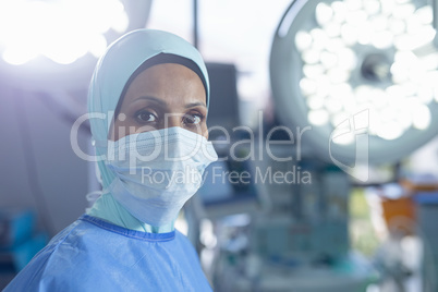 Female surgeon in hijab standing at hospital