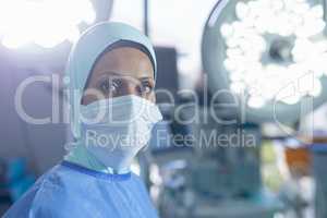 Female surgeon in hijab standing at hospital
